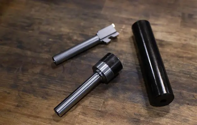 Three Pistol barrels on wooden workbench